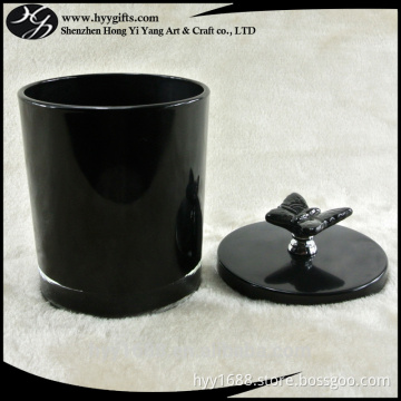 black glass candle holder with black metal lid with butterfly handle